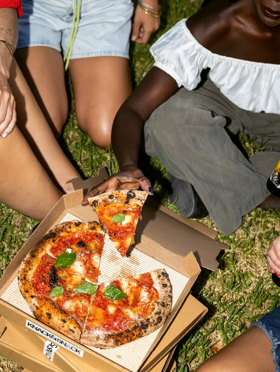 Friends sharing a Knack & Snack pizza